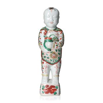 A wucai decorated porcelain figure of a laughing boy, 17th Century.