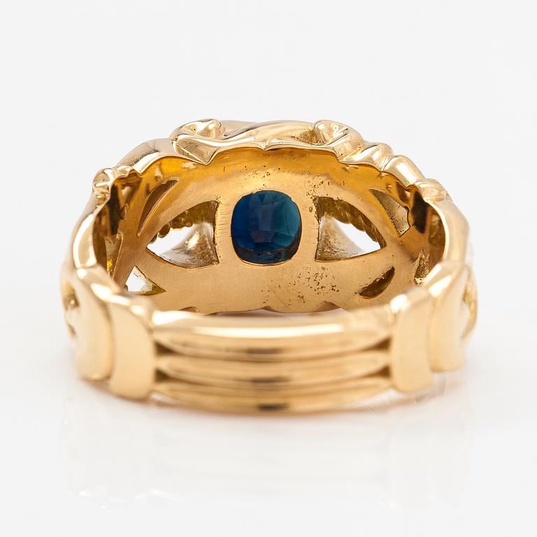 An 18K gold ring with a sapphire.