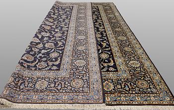 A Keshan carpet, signed, approx. 430 x 320 cm.