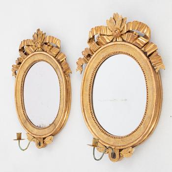 A pair of one-light Gustavian-style giltwood girandole mirrors, late 18th c /resp circa 1900.