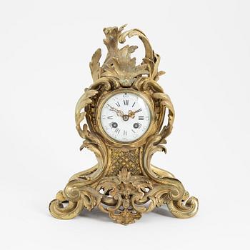 A circa 1900 brass rococo-style mantle clock.