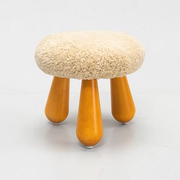 A contemporary stool with birch legs and new sheepskin upholstery.