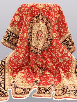 A carpet, Täbriz part silk, 341 x 248 cm.