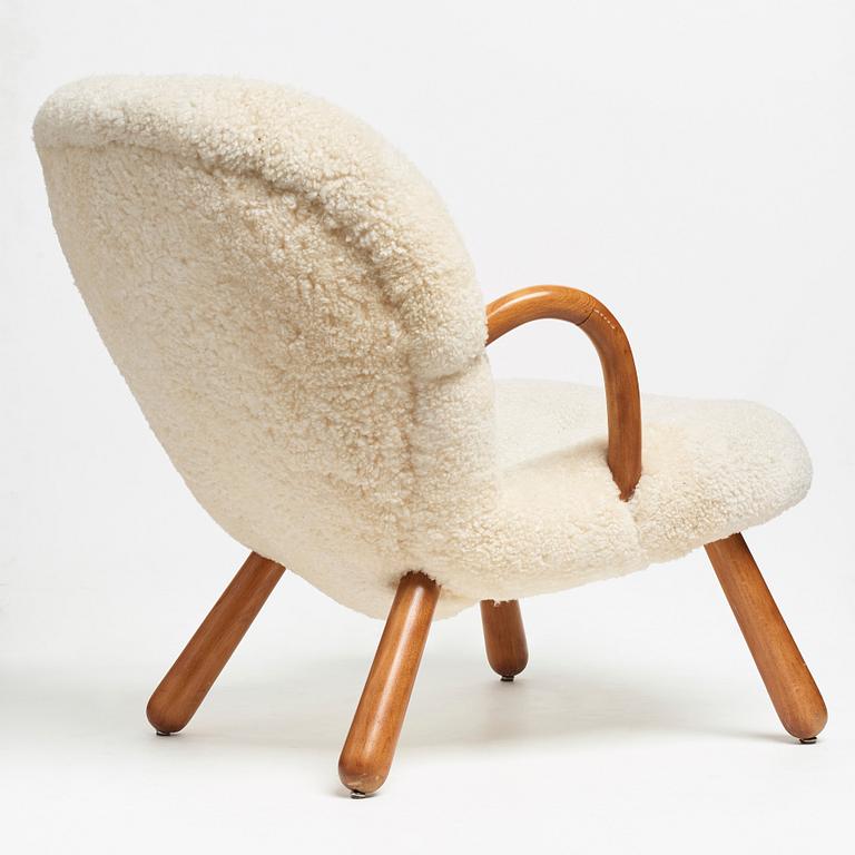 Philip Arctander, attributed to, a Clam Chair re-upholstered in white sheepskin, executed or sold by Vik & Blindheim Norway.