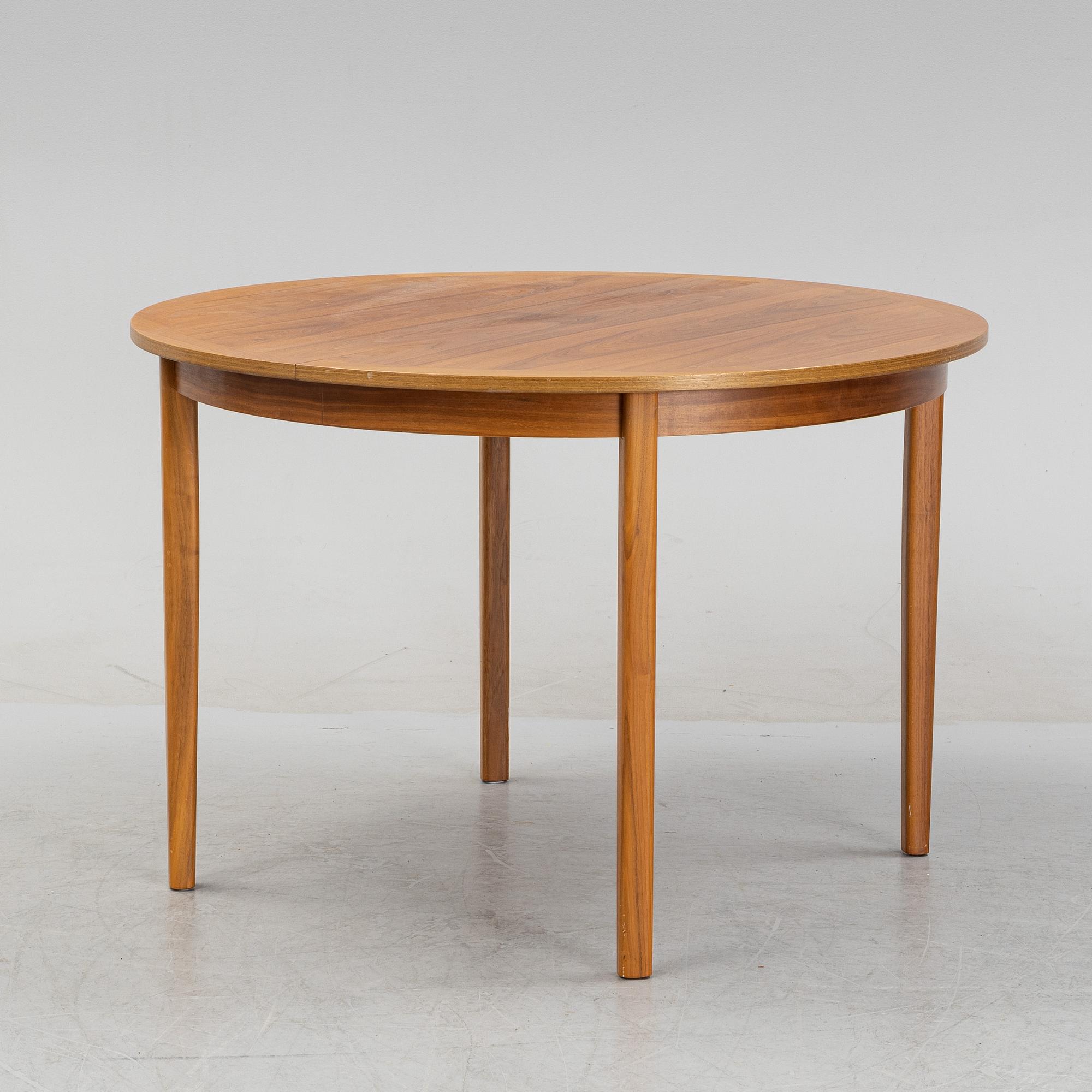 A round walnut veneered dining table.