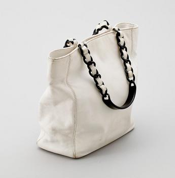 A white leather handbag by Chanel.
