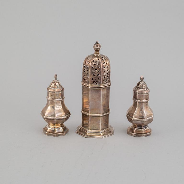 A pair of silver salts and a sugar shaker, including S W Smith & Co, London 1906.