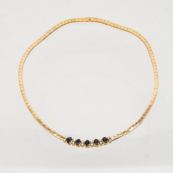 An 18K white and yellow gold necklace set with oval-cut sapphires and round brilliant-cut diamonds.