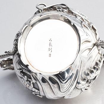 A three piece japanse silver 'dragon' tea set, Signed 三代目 大島, third generation Oshima, early 20th Century.