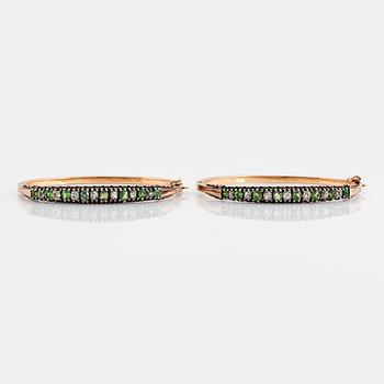 1004. A pair of 14K gold and silver bangles set with demantoid garnets and old-cut diamonds.