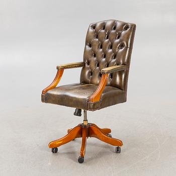 An English 21st century addjustable leather desk chair.