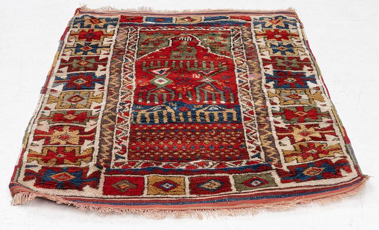 An antique Anatolian rug, c 136-147 x 104 cm (including flat weave).