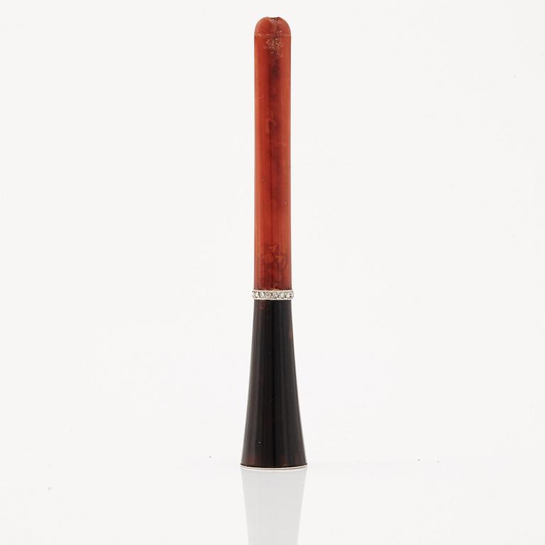 A 1920's cigarette holder of tortoiseshell and meerschaum decorated with rose-cut diamonds.
