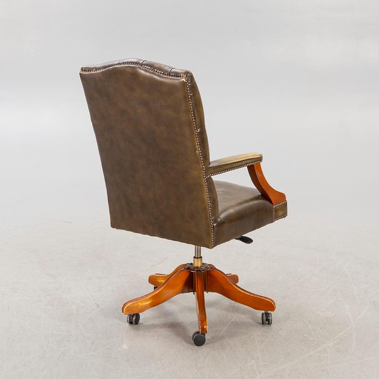 An English 21st century addjustable leather desk chair.