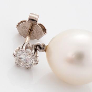 A pair of 18K white gold earrings set with round brilliant-cut diamonds and cultured pearls.