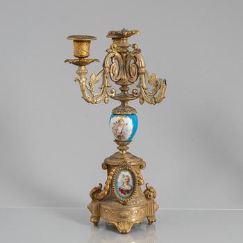 A Louis XVI style mantel clock and a pair of candelabra, circa 1900.