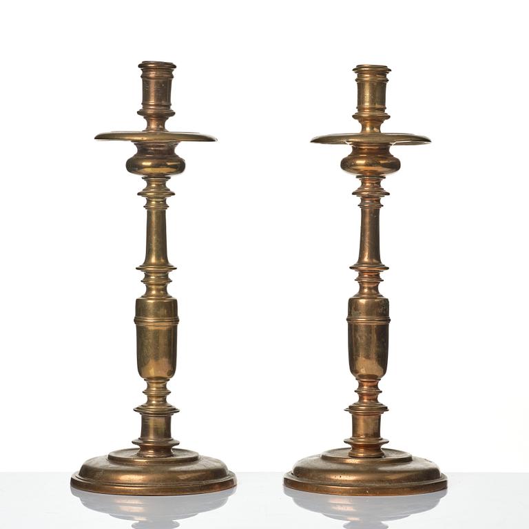 A pair of baroque brass candlesticks, 18th century.