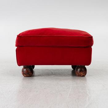 A pair of Howard-style armchairs and a footstool, late 20th century.