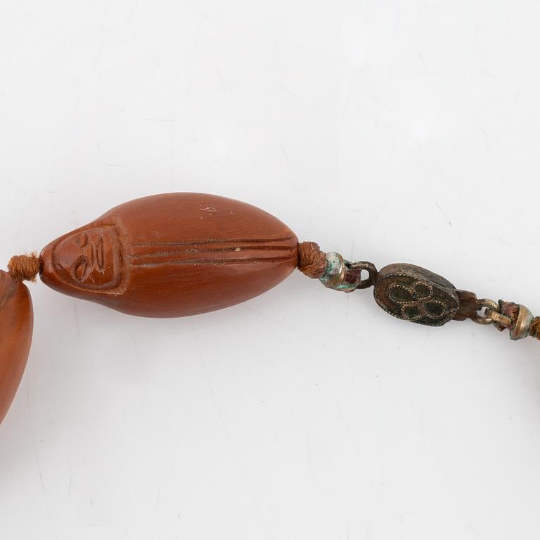 A necklace with sculptured nuts, circa 1900.