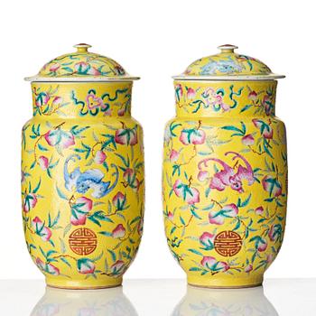 A pair of yellow glazed peach and bat vases with covers, Qing dynasty, 19th Century.