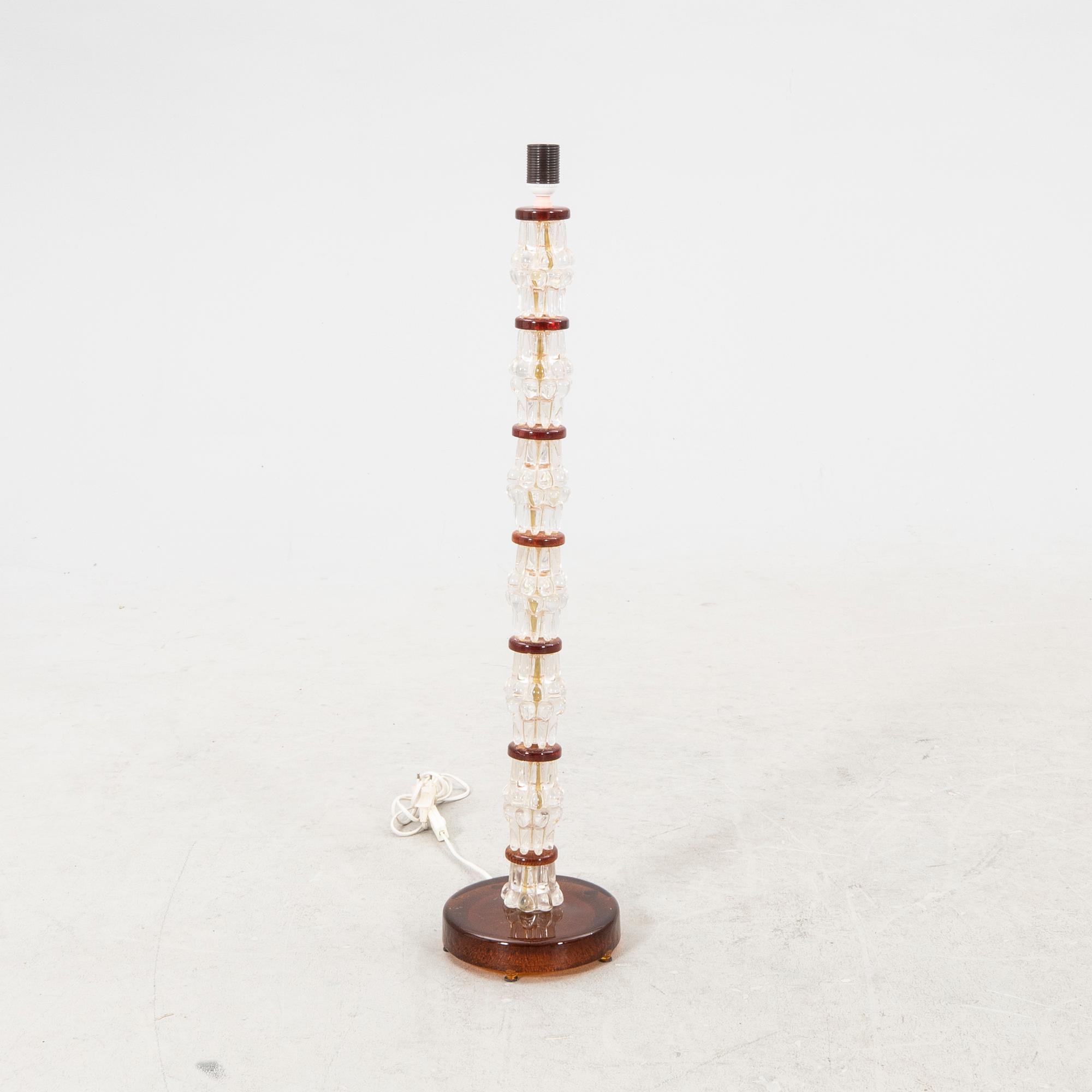 A 1970s glass floor lamp.