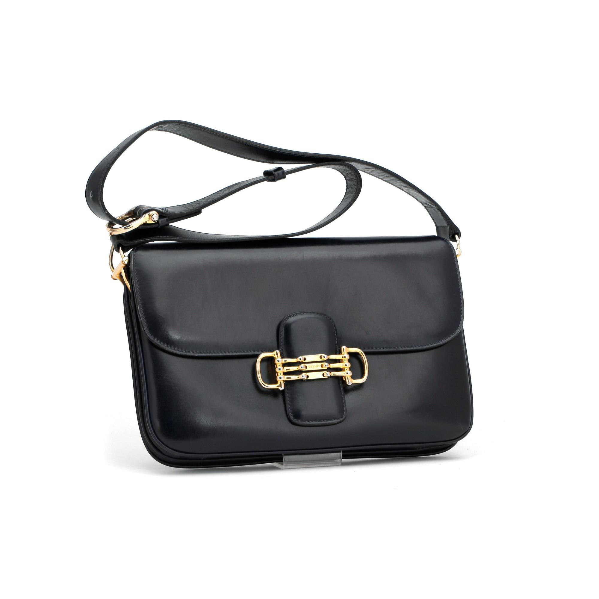 CÉLINE, a dark blue leather shoulder bag.
