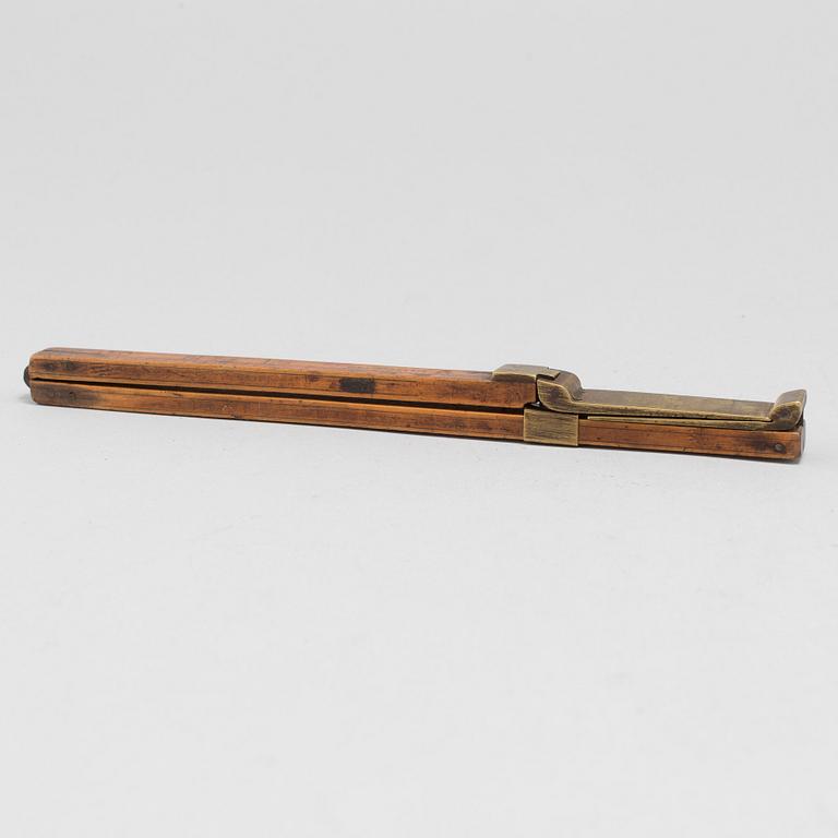 A 19th century wooden measuring stick.