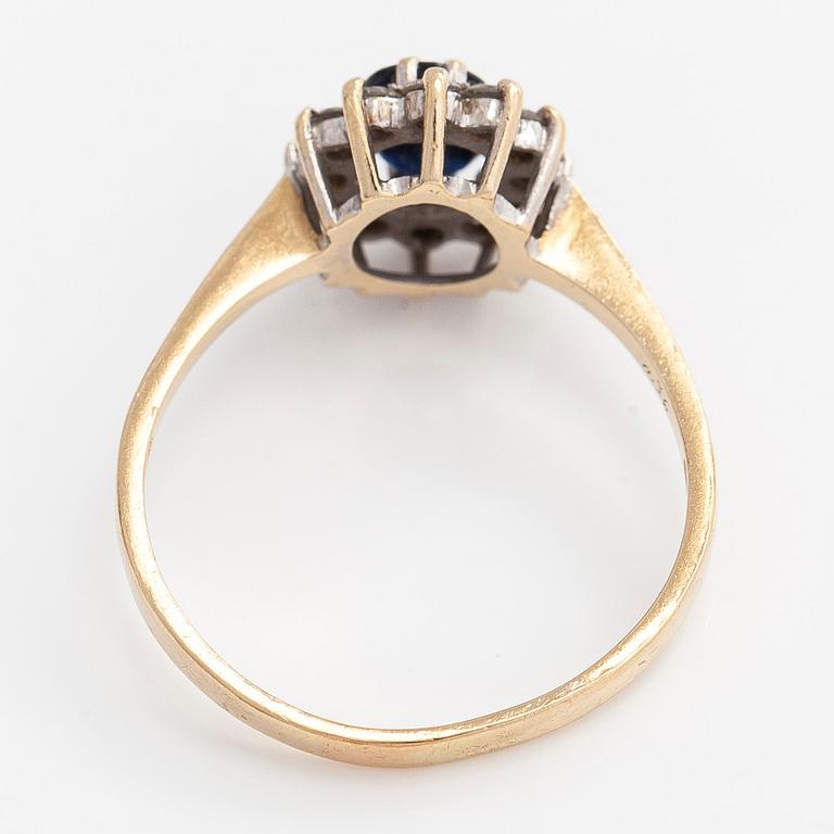 A 14K gold ring, with an oval faceted sapphire and diamonds, England.