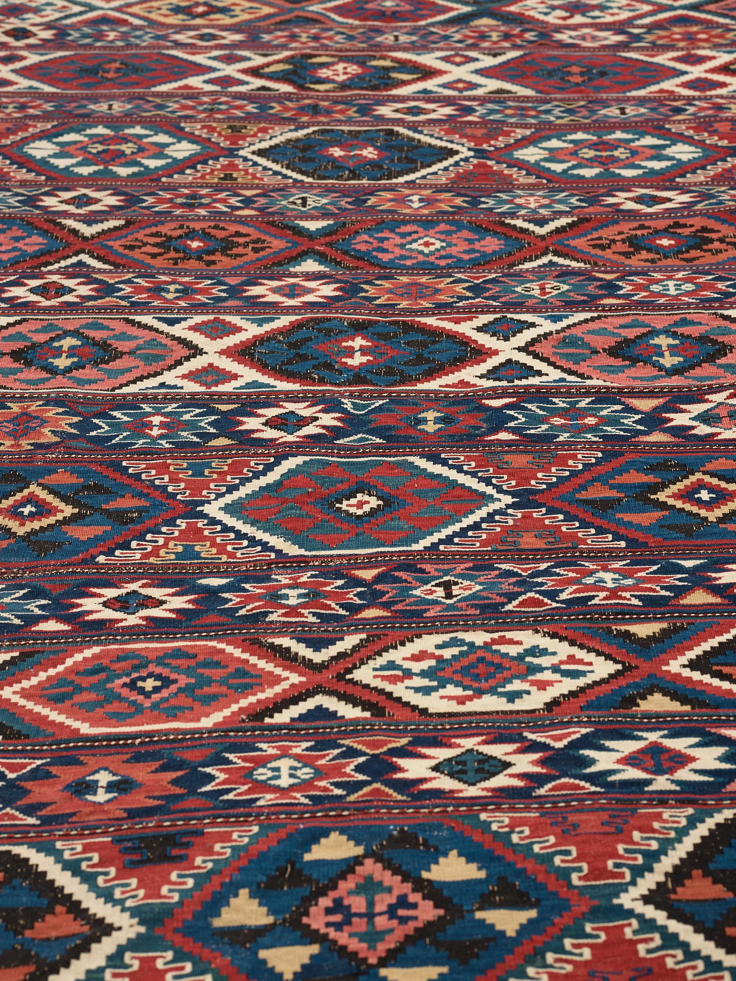 A CARPET, AN ANTIQUE AZERI KILIM, probably a Shirvan, ca 250 x 117,5 cm.