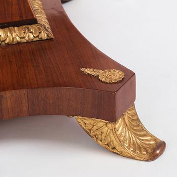 A north european Empire  'Umdruck'-decorated mahogny and gilded metal table.