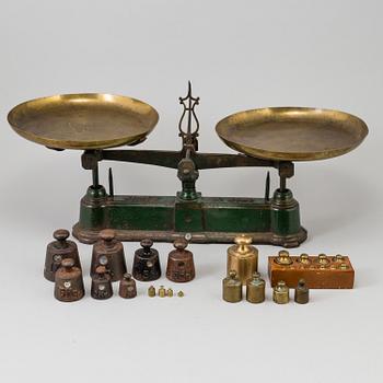 A 20th century cast iron balance with brass and iron weights, partly Skultuna, Sweden.