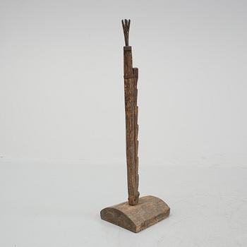 A 18th century wooden floor candle holder.