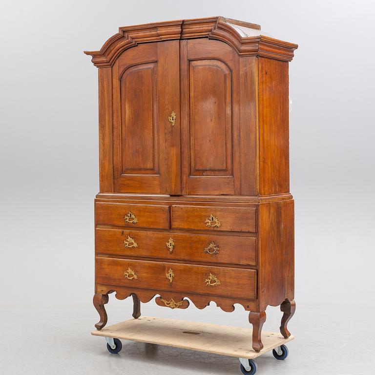 A mid 18th century rococo oak cabinet.