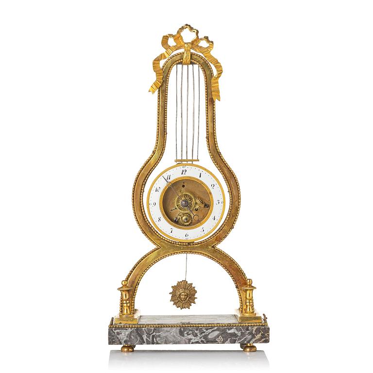 A French Louis XVI ormolu and marble lyre-shaped mantel clock, late 18th century.
