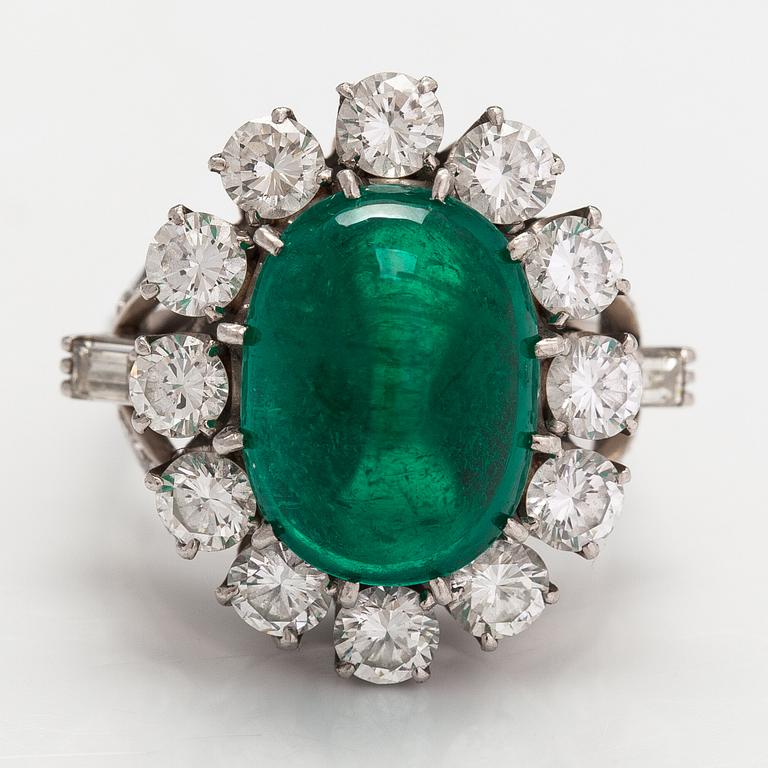 A platinum ring with a ca. 8.50 ct emerald and diamonds ca. 2.84 ct in total. With certificate.