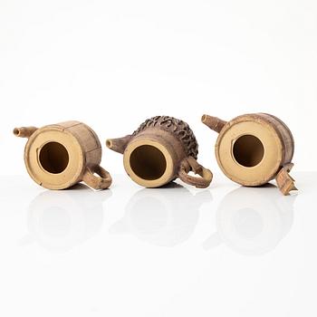 A group of three bright yellow yixing 'Gongfu' teapots, China, 1990s.