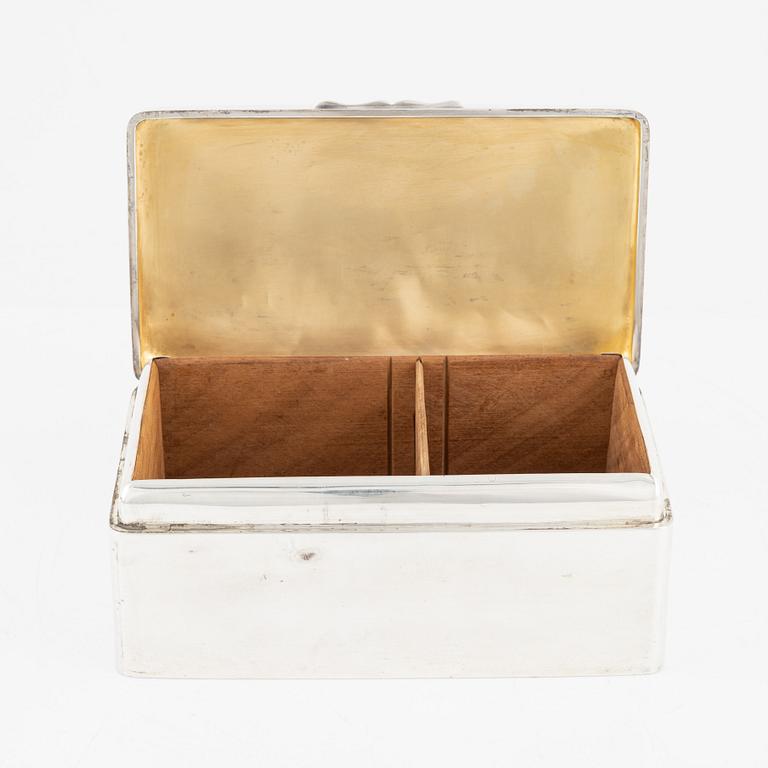 A silver cigarette box, Walker & Hall, Birmingham, England, 1919.