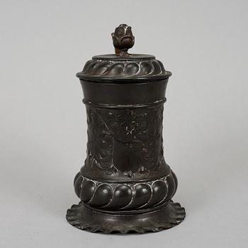 An 18th century copper mug.