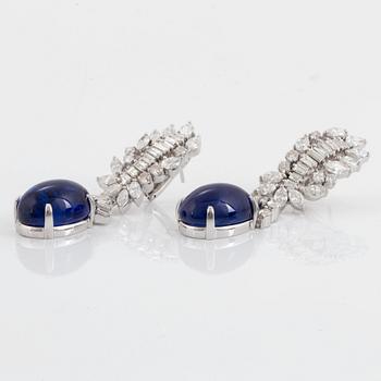 A pair of 18K gold tanzanite earings set with diamonds of various shapes.