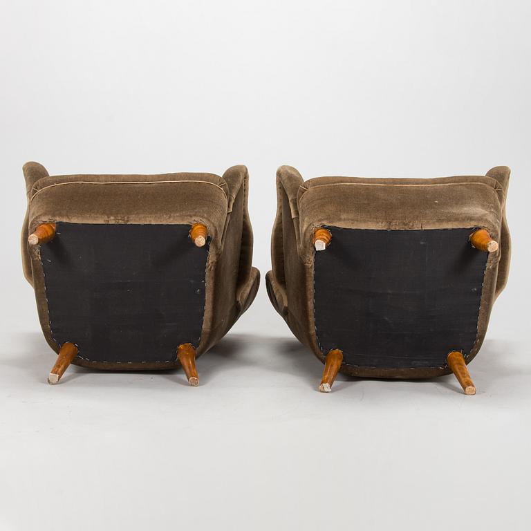A pair of mid-20th century armchairs.