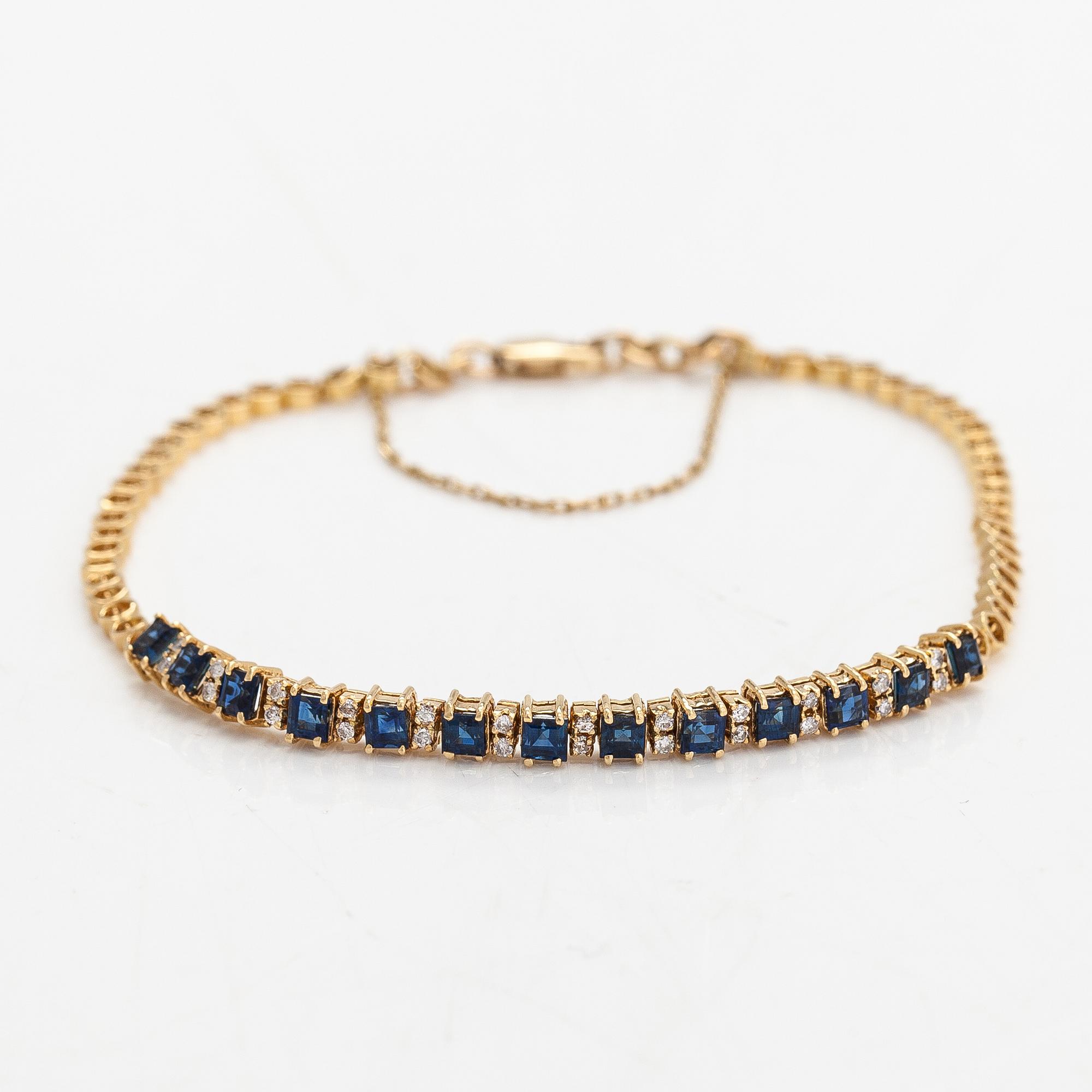 Rannkoru, 14K kultaa, timantteja n. 0.12 ct yht ja safiireja.