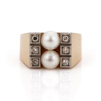 A ring set with two cultured pearls and eight-cut diamonds.