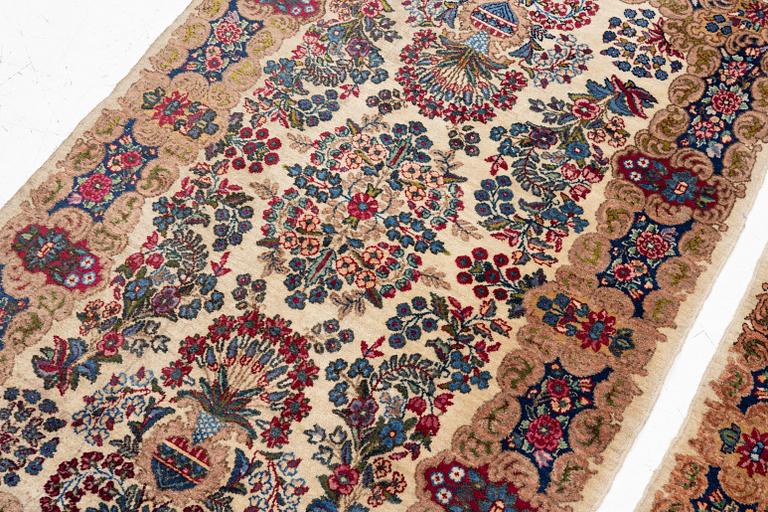 A pair of similar Kirman rugs, south Persia, c. 147 x 94 and 154 x 96 cm.