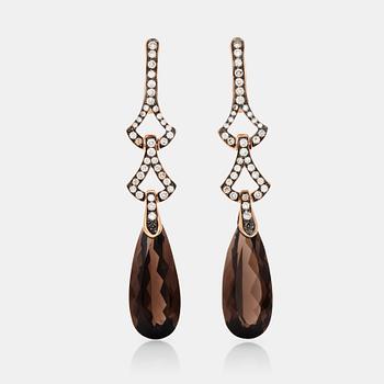 565. A pair of smoky quartz and diamond, circa 1.25 in total, earrings.