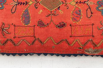 An embroidered carriage cushion, 100 x 50 cm, dated 1852.