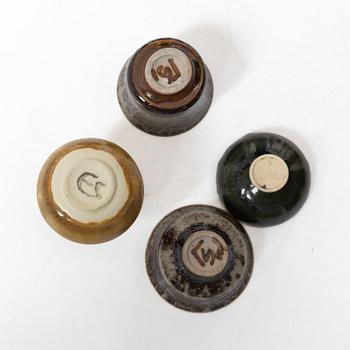 A set of fourteen stoneware vases and ten bowls, predominantly John Andersson, Höganäs.