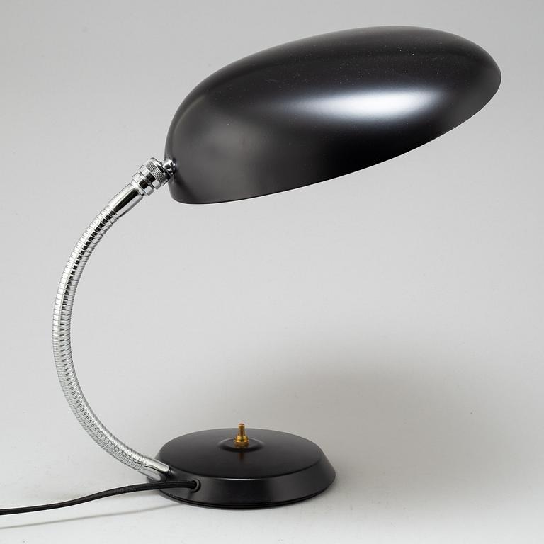A 'Cobra' table lamp by Greta Magnusson Grossman, Gubi.