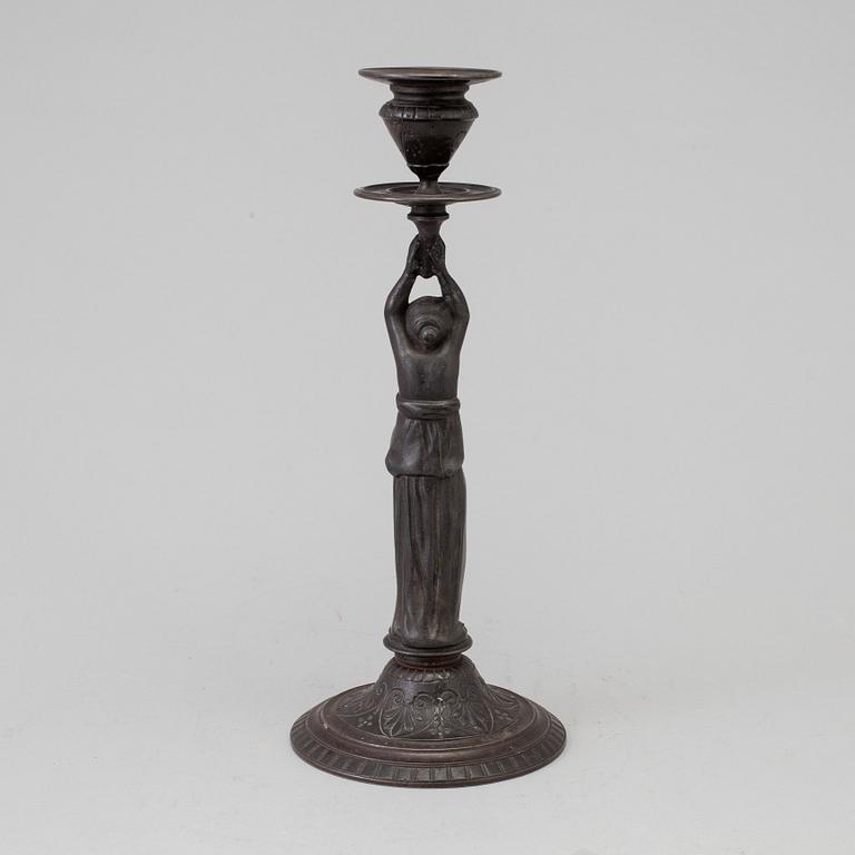 A 19th century iron candlestick marked F.L Vombach Offenbach A/M.