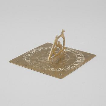 A brass sundial dated 1715.