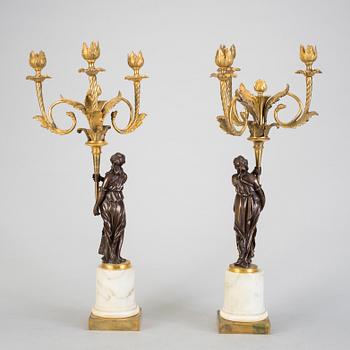 A pair of 19h Century Louis XVI style three-light candelabra in bronze and marble.